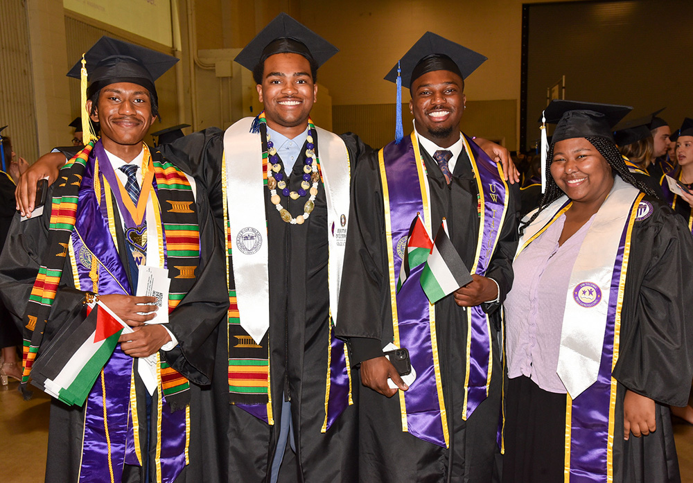 Photo of group of students at graduation wearing regalia