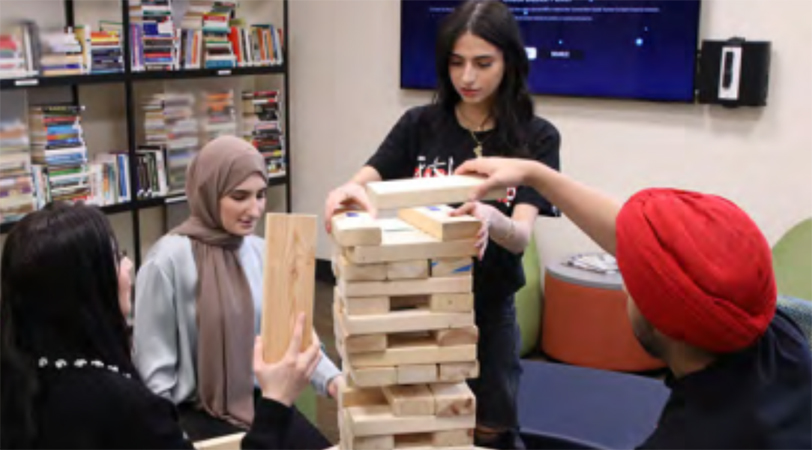 Students playing giant game of Jenga