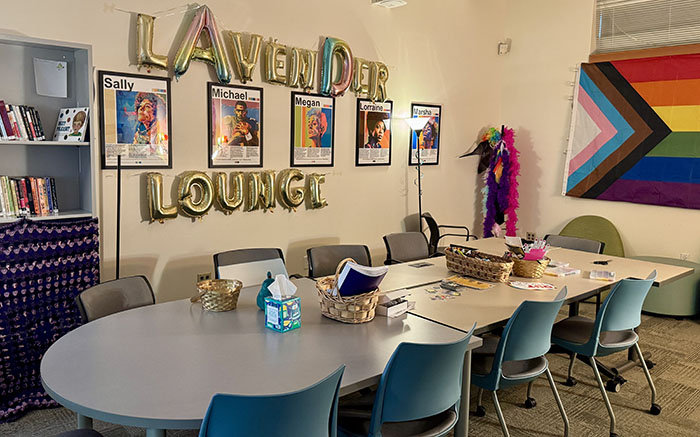 Equity and Inclusion Lavendar Lounge with a table, pride flag, and decorations