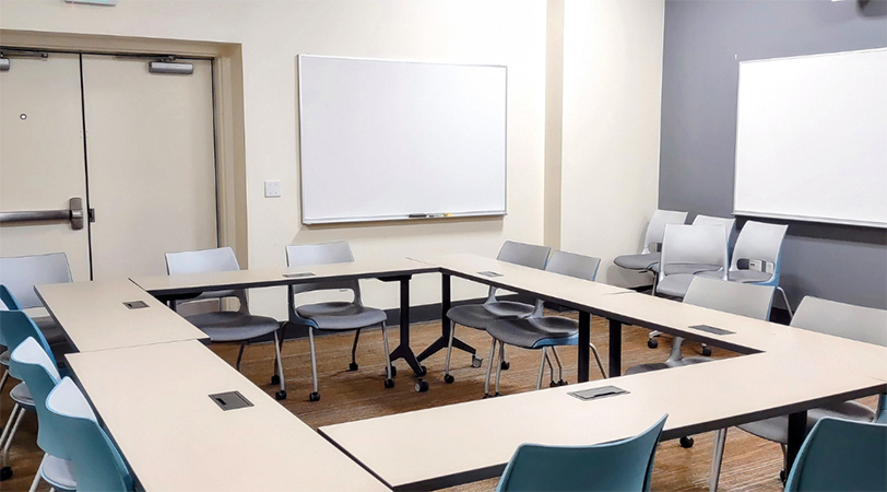 Desks and whiteboards in an empty classroom