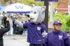 UW Tacoma mascot Hendrix the Husky waving to a group of students offscreen 