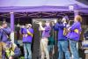 Band playing trumpets and a saxophone onstage at Huskyfest